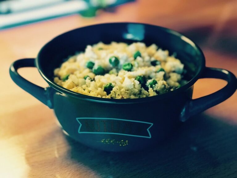 Cauliflower rice in a dark skillet